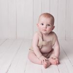 Baby sitting on wooden floor